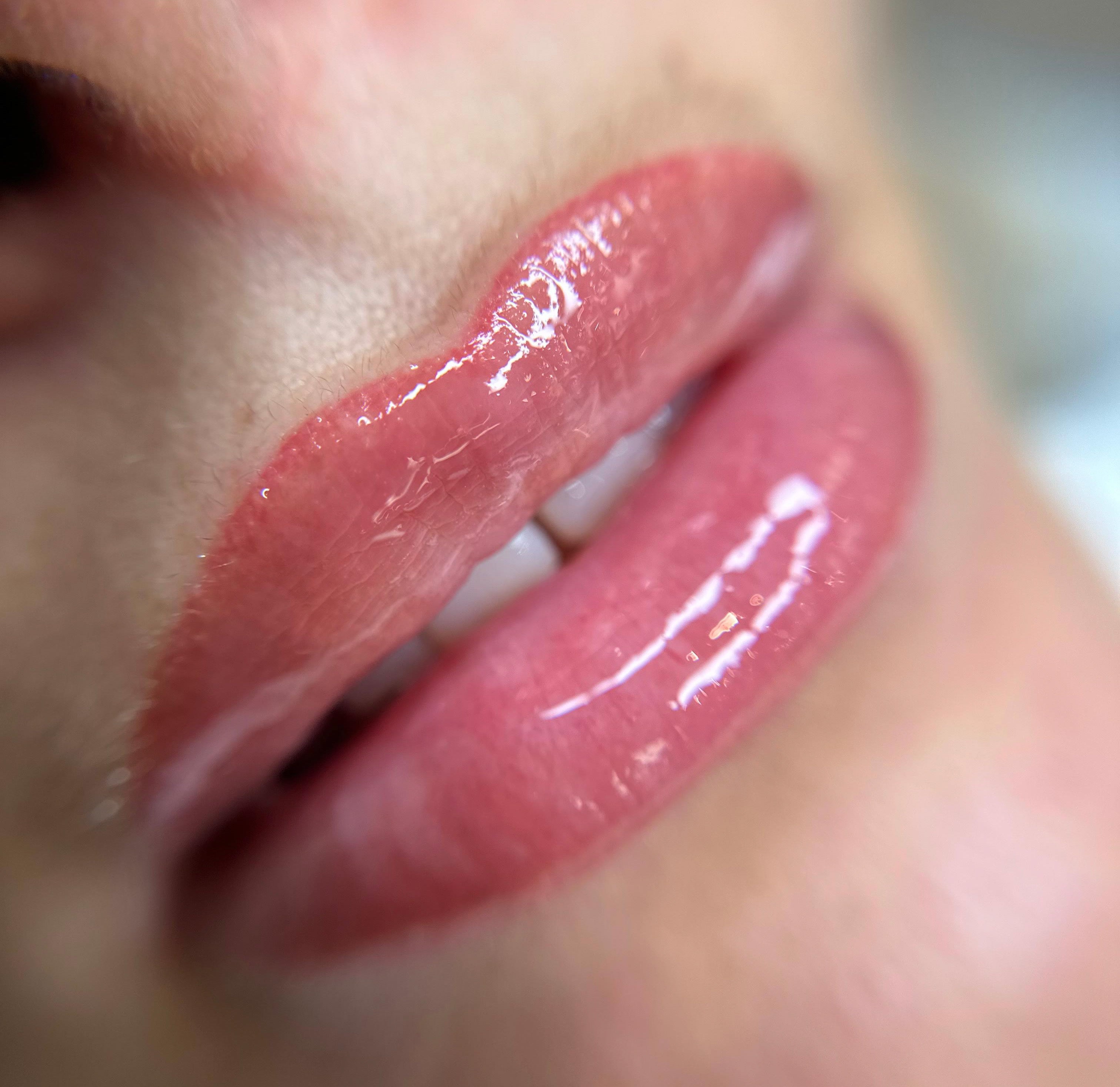 Close-up of freshly applied lip blushing with a glossy finish at ME Beauty Bar.