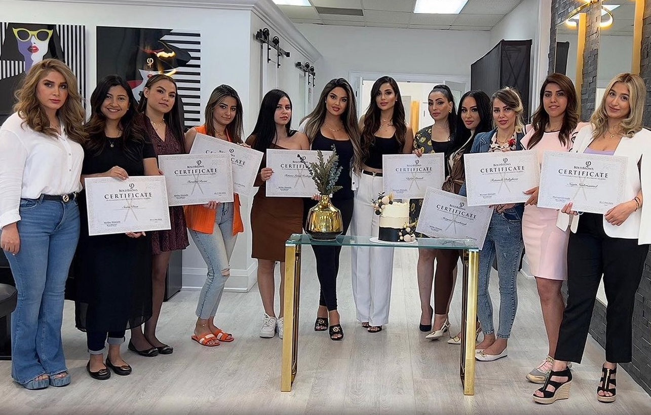 Melika Ehtesabi with her microblading workshop students holding certificates at ME Beauty Bar.